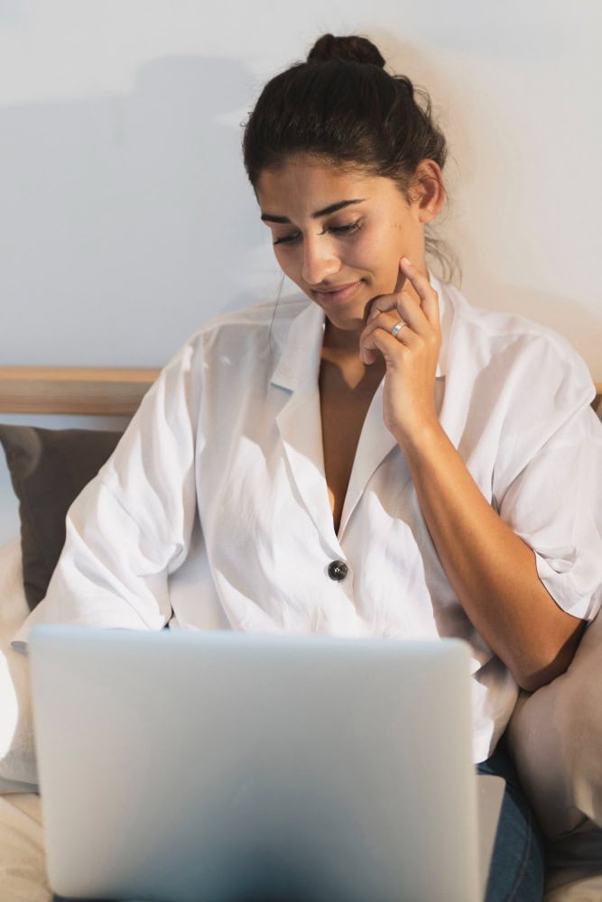 Woman using laptop during online addiction treatment in Washington session