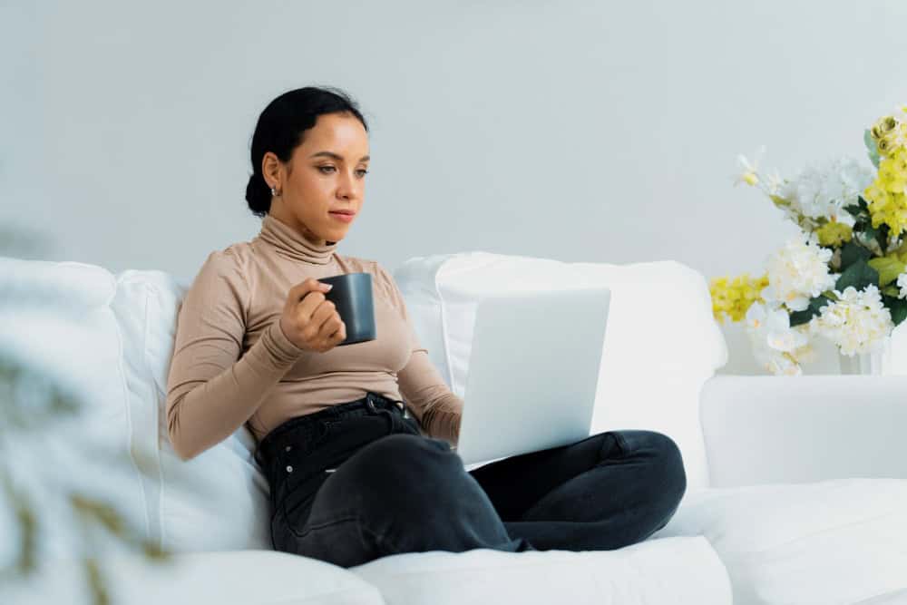 Woman using laptop at home during Washington Addiction Treatment online session