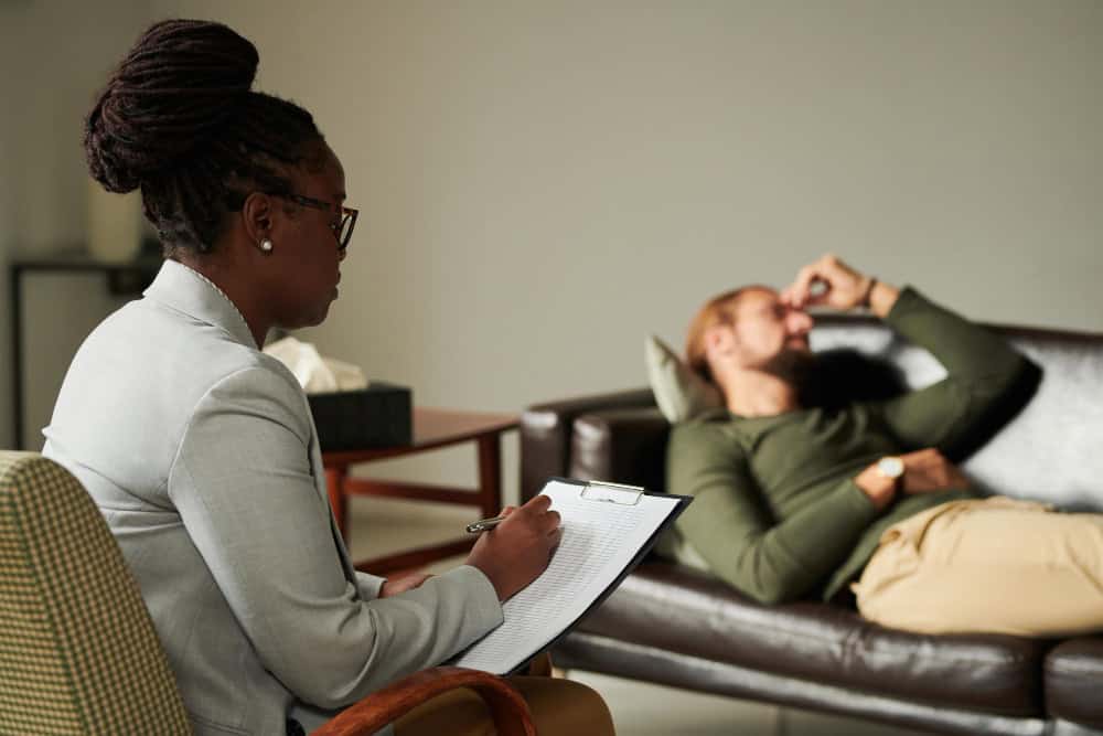 Psychologist taking notes while working with a patient during an IOP in Washington State at Clarity Healthcare.